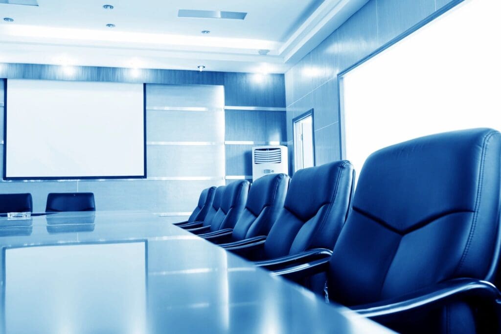 a meeting room with chairs and projector