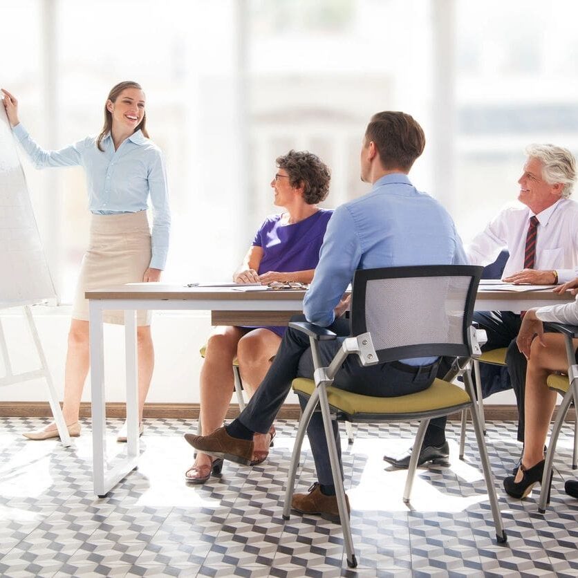 A woman standing in front of a group of people.